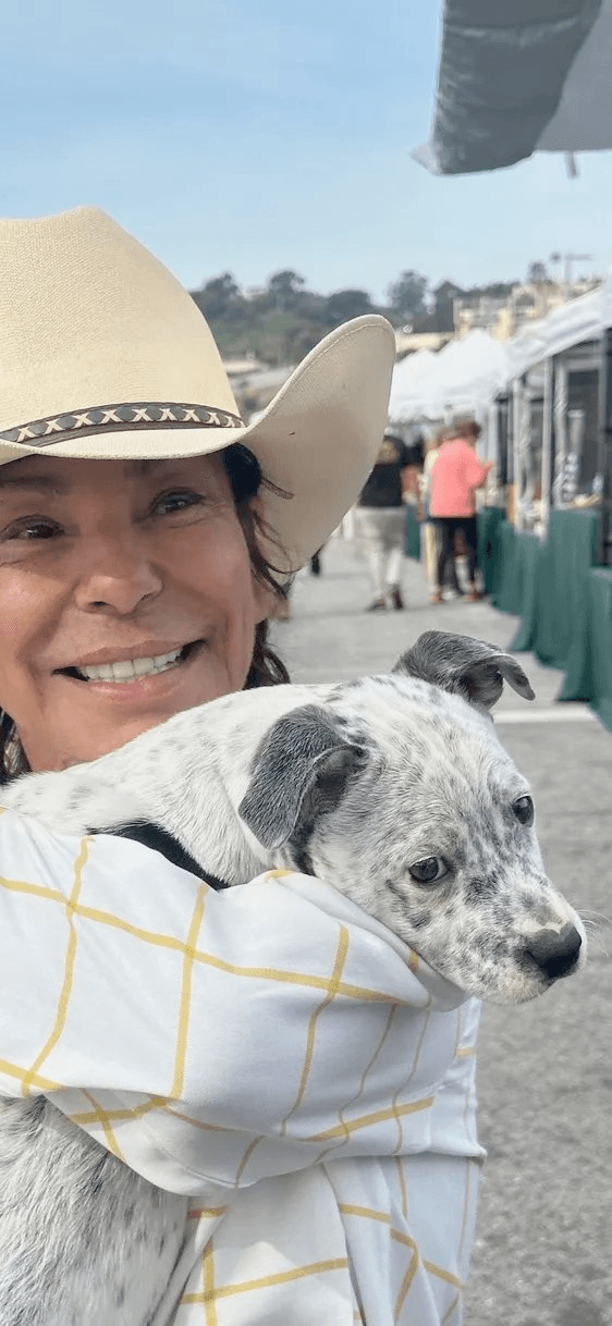 Woman holding puppy at market